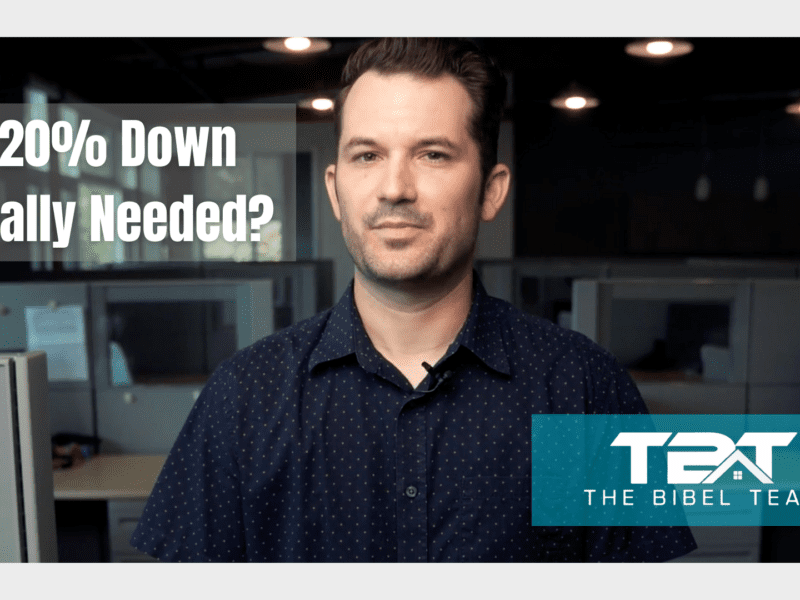 Man in a navy blue polo shirt with short brown hair stands in the NEO Home Loans office