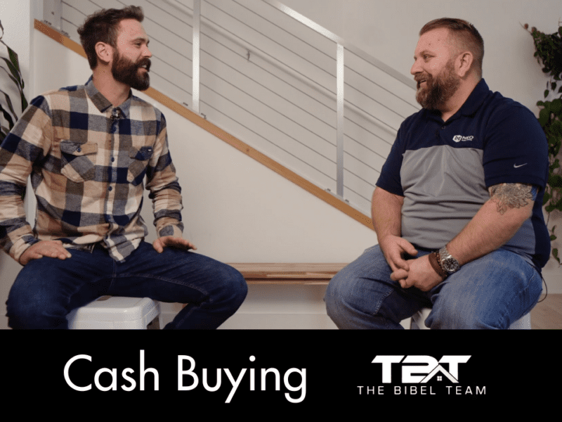 Eric and Brad sit in chairs in front of an aluminum stair rail